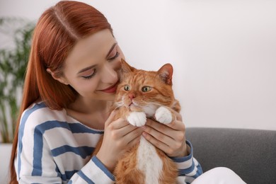 Woman with her cute cat at home