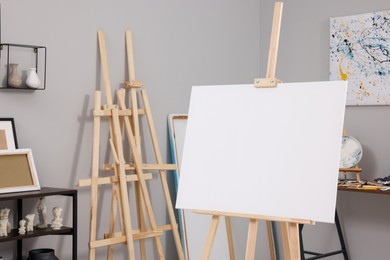 Photo of Artist's studio with easels, canvases, vases and small sculptures