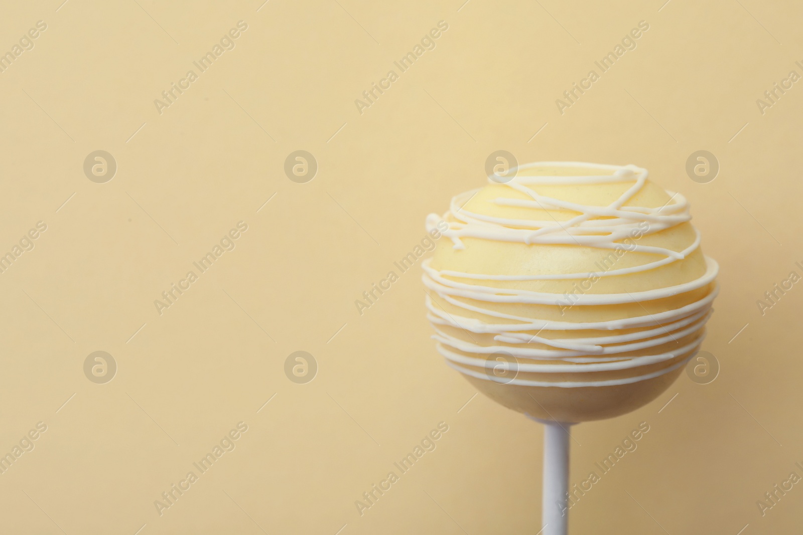 Photo of Sweet cake pop on yellow background, space for text