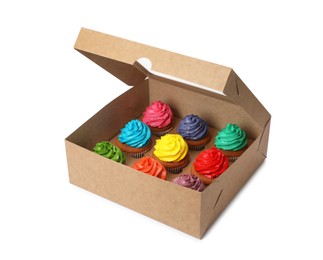 Photo of Box with delicious colorful cupcakes isolated on white