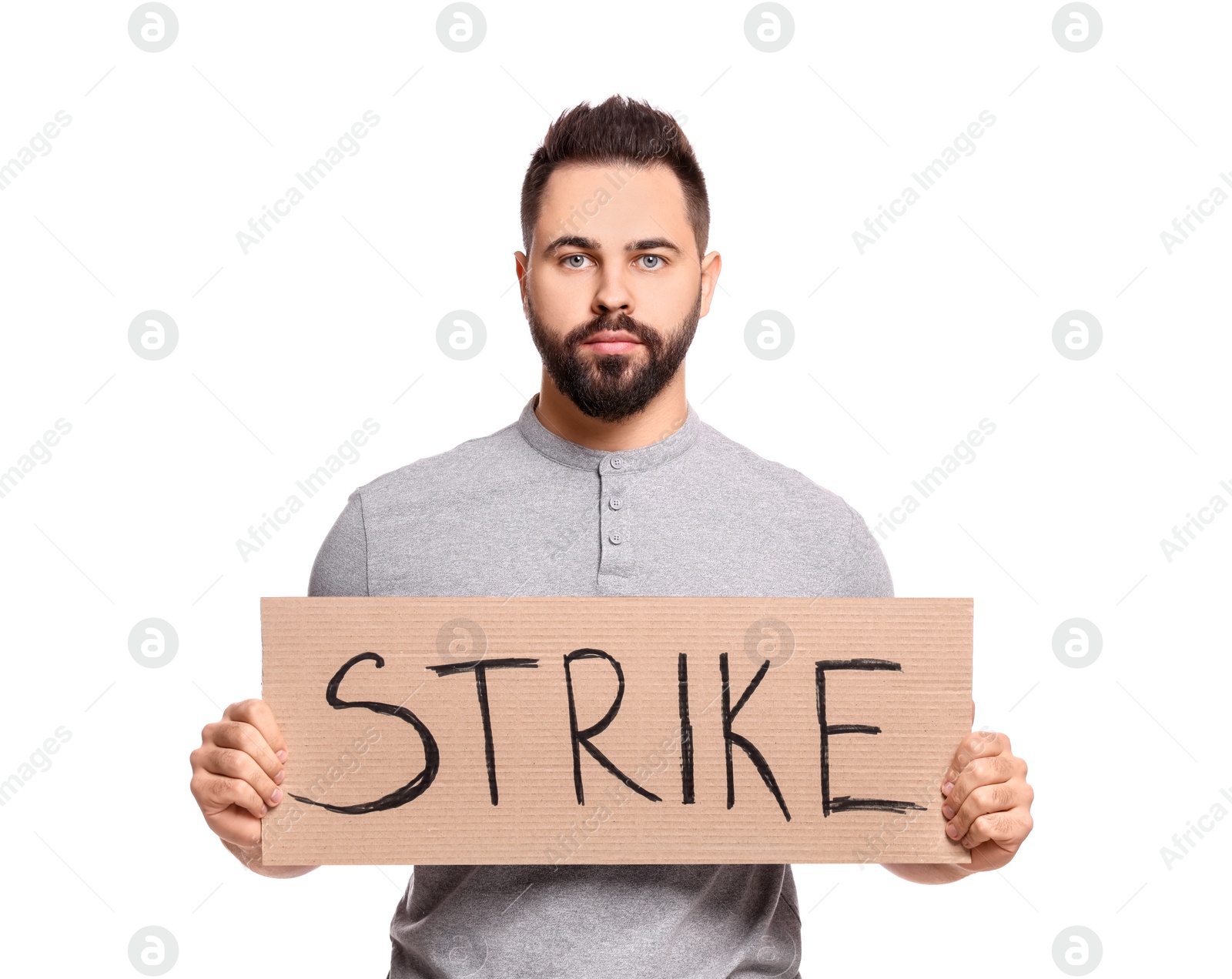 Photo of Young man holding cardboard banner with word Strike on white background