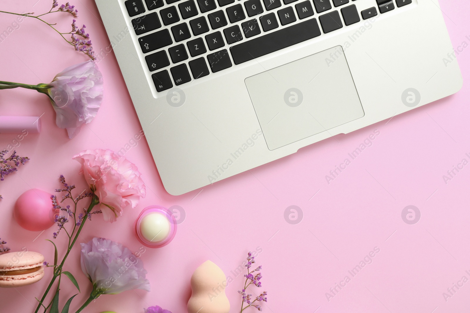 Photo of Flat lay composition with laptop on pink background. Beauty blogger's workplace