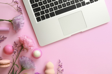Flat lay composition with laptop on pink background. Beauty blogger's workplace
