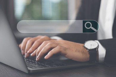 Image of Search bar of website over laptop. Man using computer at wooden table, closeup