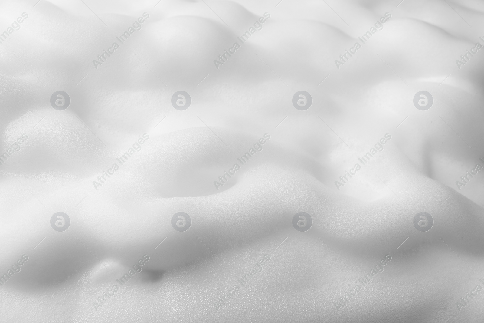 Photo of Foam as background, closeup. Face cleanser, skin care cosmetic