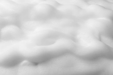 Photo of Foam as background, closeup. Face cleanser, skin care cosmetic