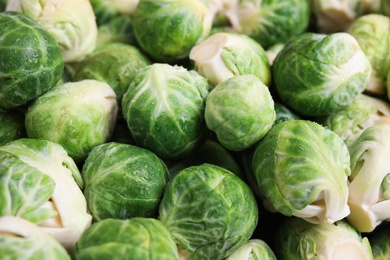 Photo of Fresh tasty Brussels sprouts as background, closeup