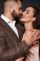 Photo of Handsome bearded man with sexy lady on grey background