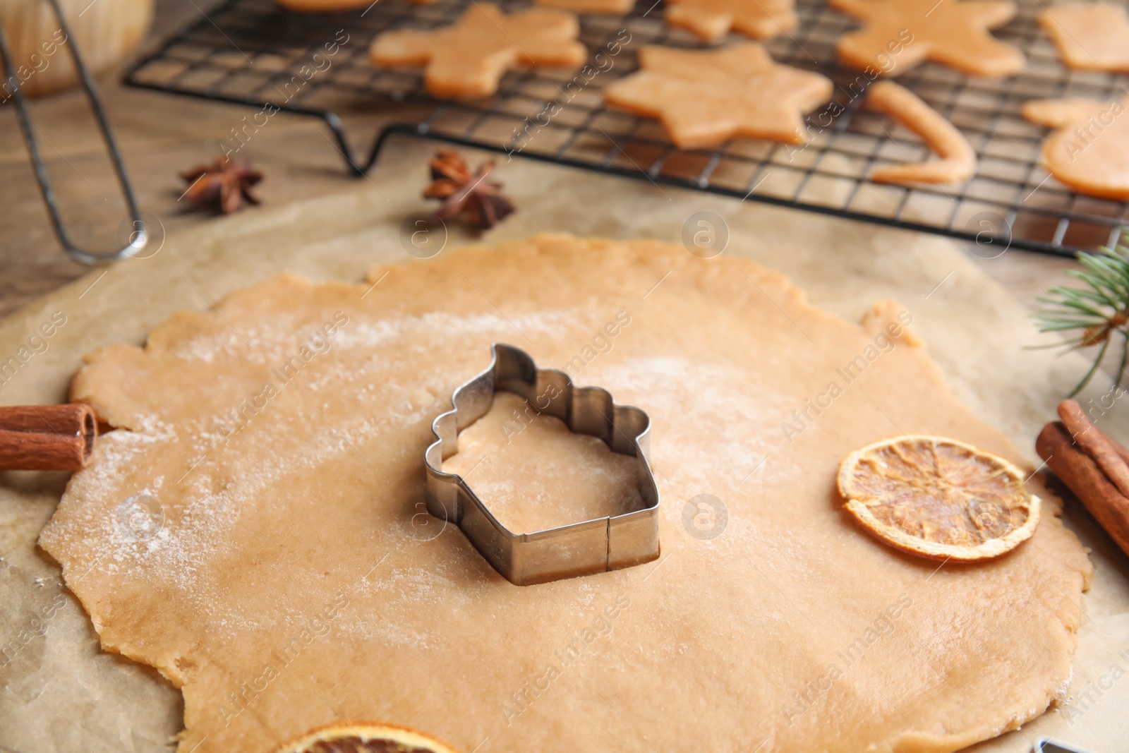 Photo of Making homemade Christmas cookies. Dough and cutter on table, closeup