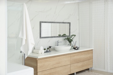 Photo of Modern bathroom interior with stylish mirror and vessel sink