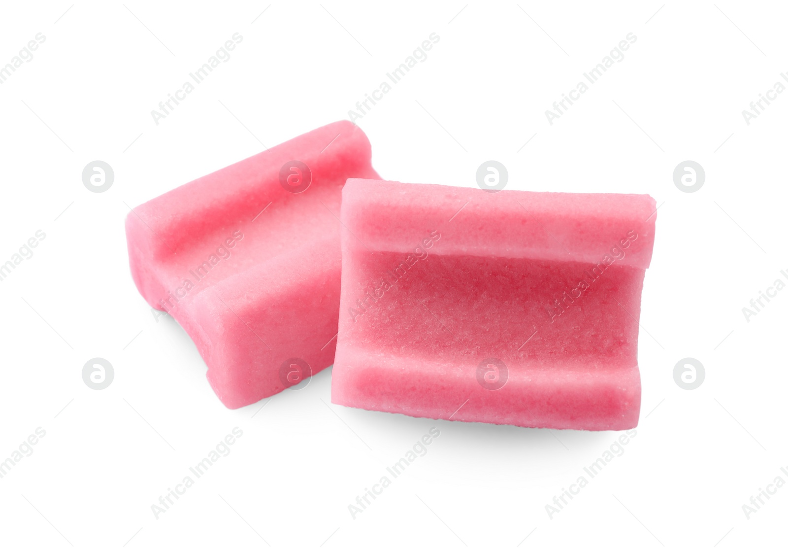 Photo of Tasty pink chewing gums on white background