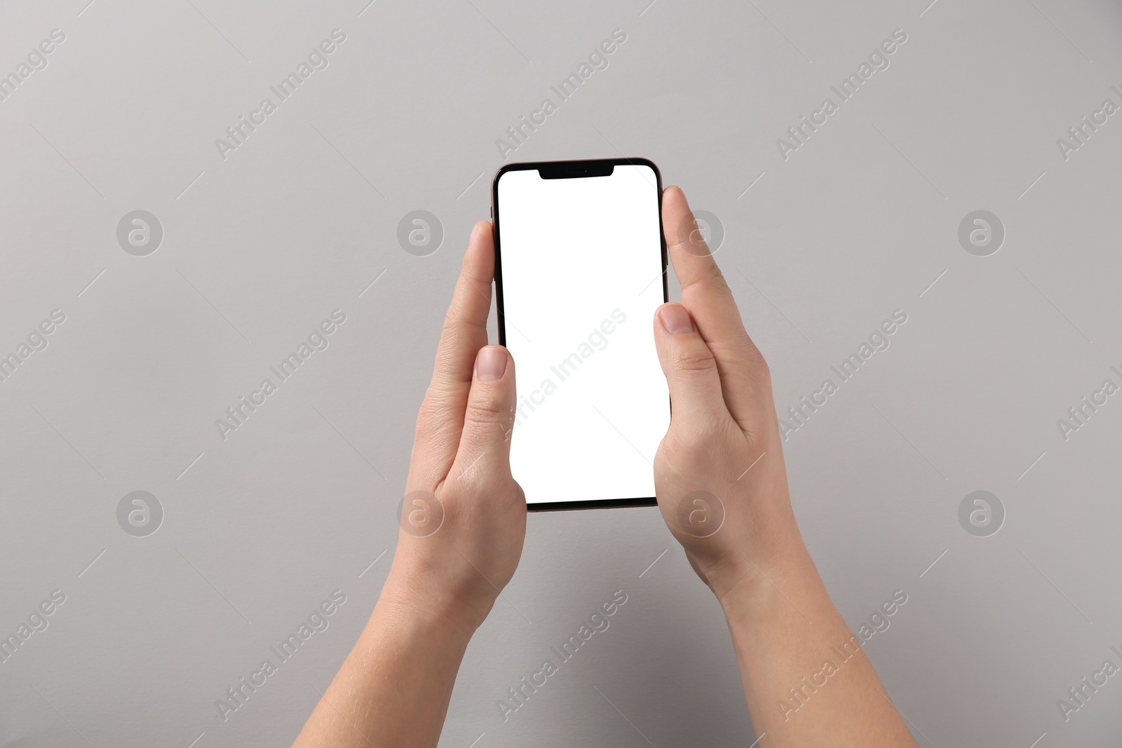 Photo of Man with smartphone on grey background, top view