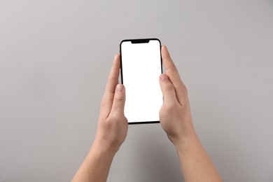 Photo of Man with smartphone on grey background, top view