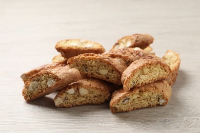 Photo of Tasty cantucci on white wooden table. Traditional Italian almond biscuits