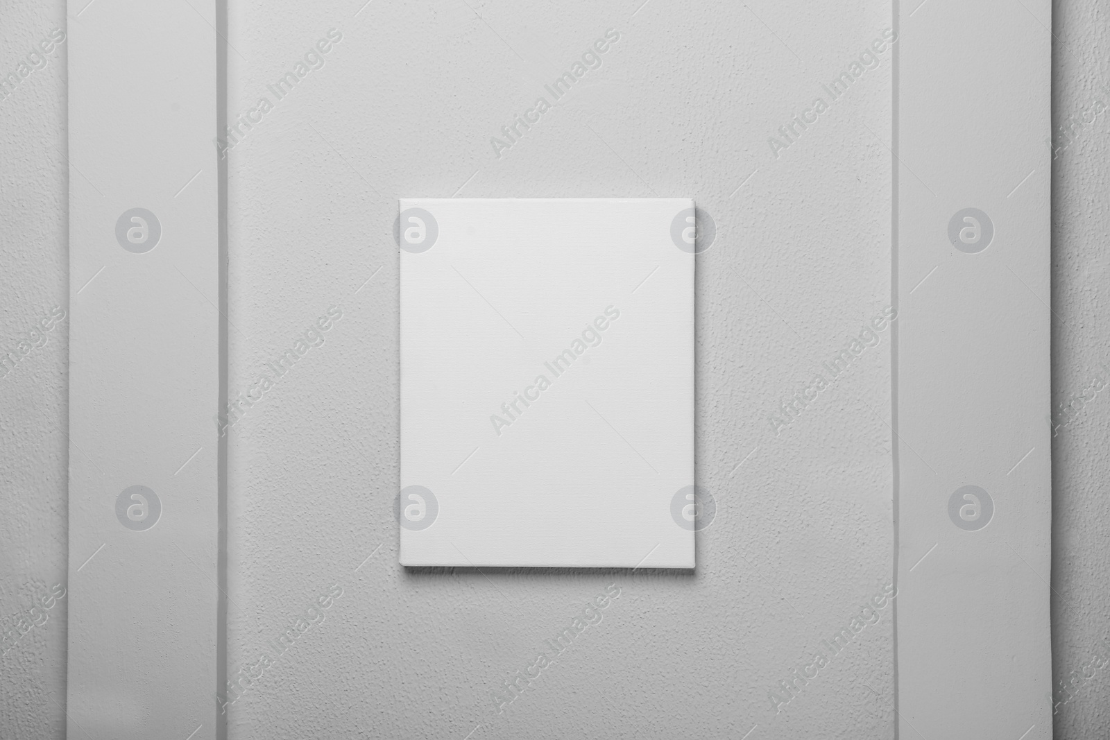 Photo of Blank canvas on white wall. Space for design