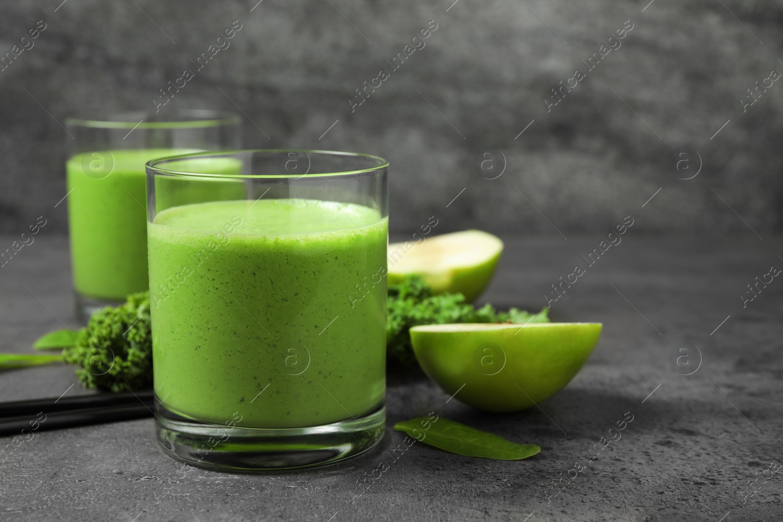 Photo of Tasty fresh kale smoothie on grey table