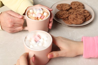 Photo of Women having coffee break at marble table, closeup