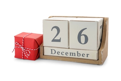 Photo of Wooden block calendar with date 26th of December near gift on white background. Boxing day