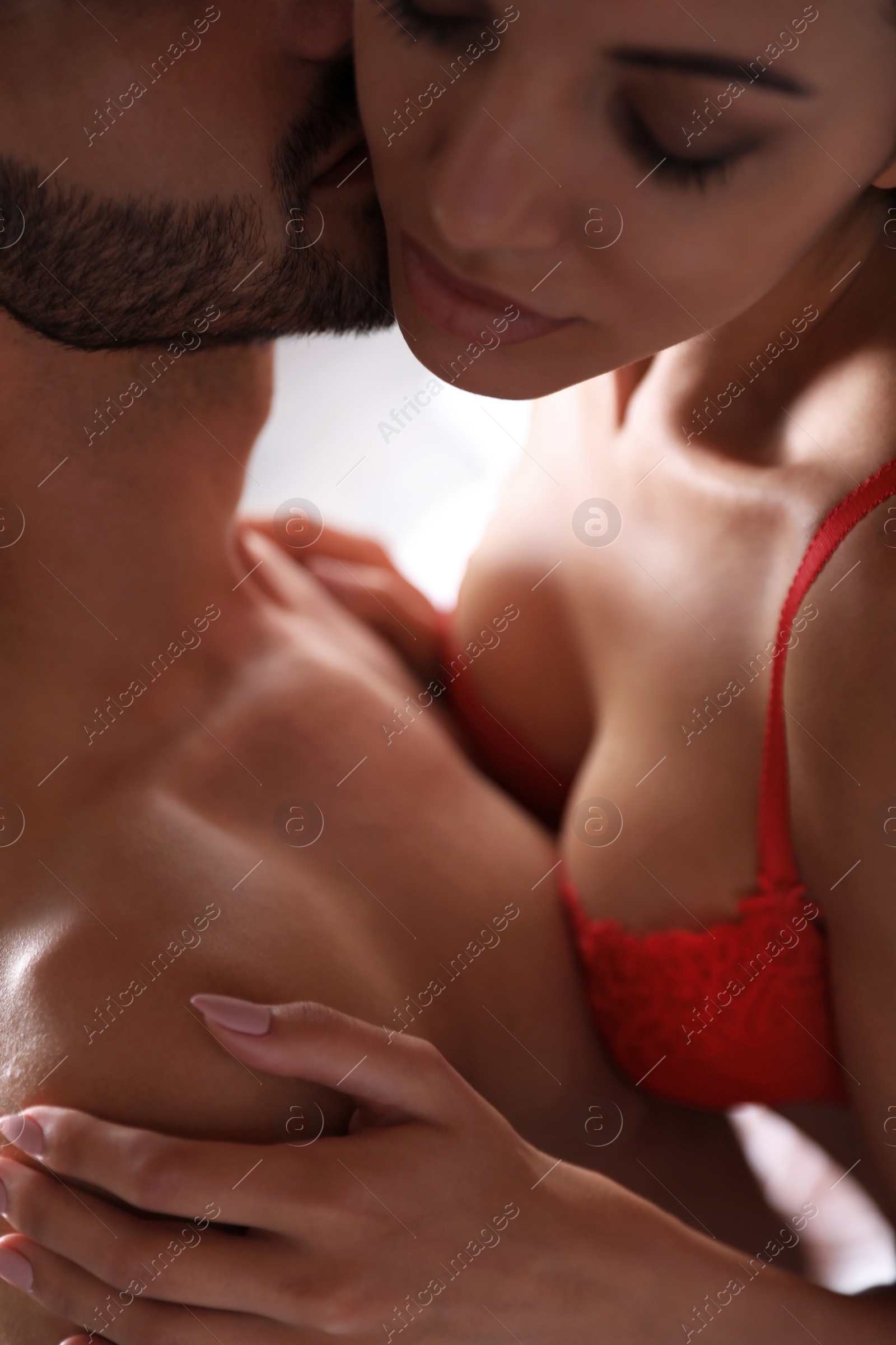 Photo of Passionate young couple having sex indoors, closeup