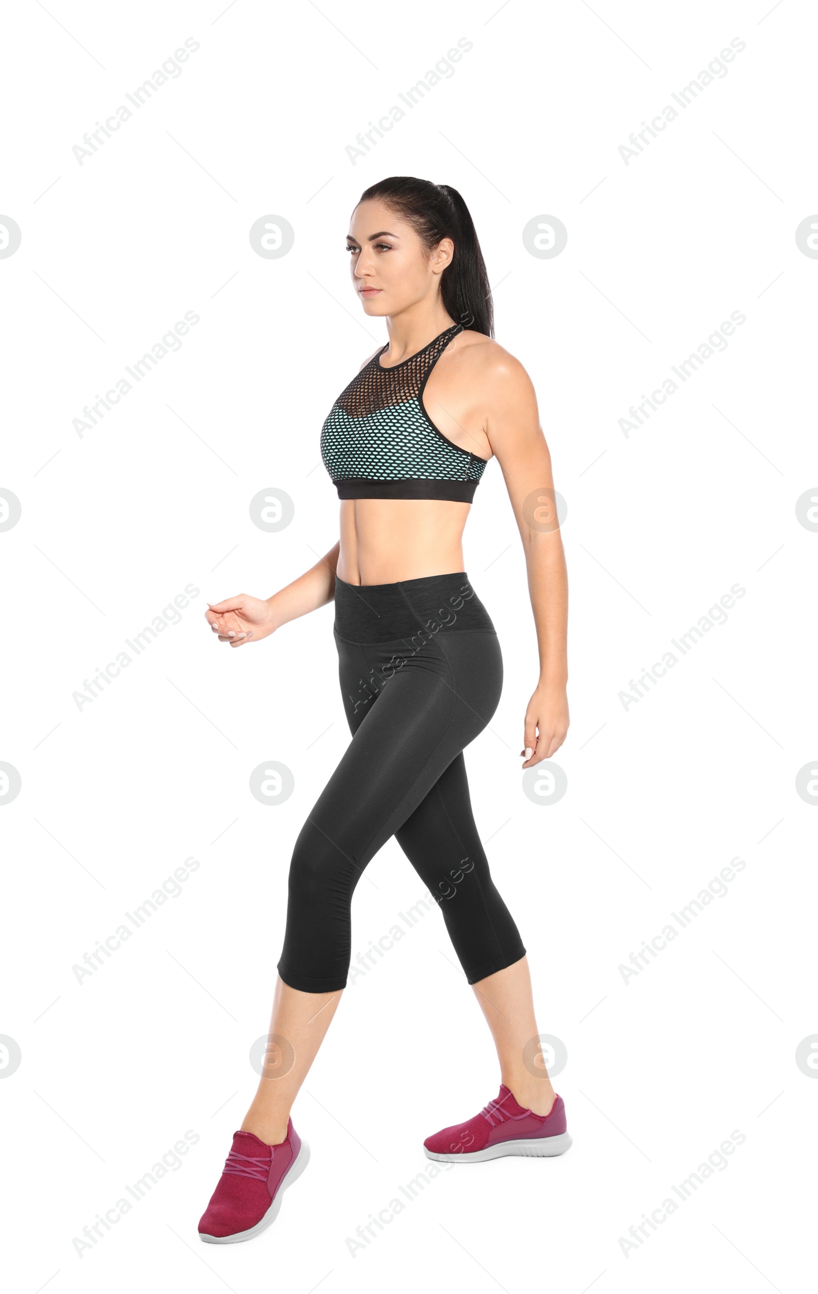 Photo of Sporty young woman running on white background