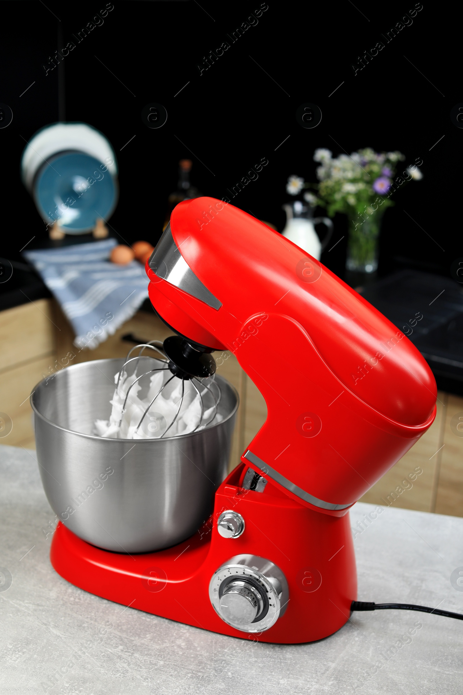 Photo of Modern stand mixer on table in kitchen. Home appliance