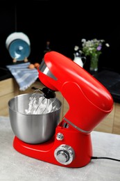 Photo of Modern stand mixer on table in kitchen. Home appliance