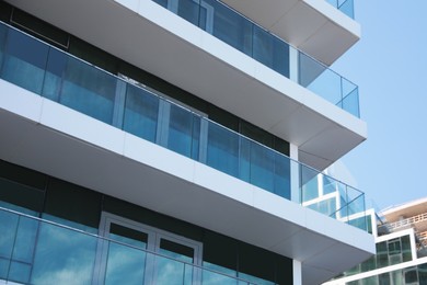 Exterior of residential building with balconies, low angle view