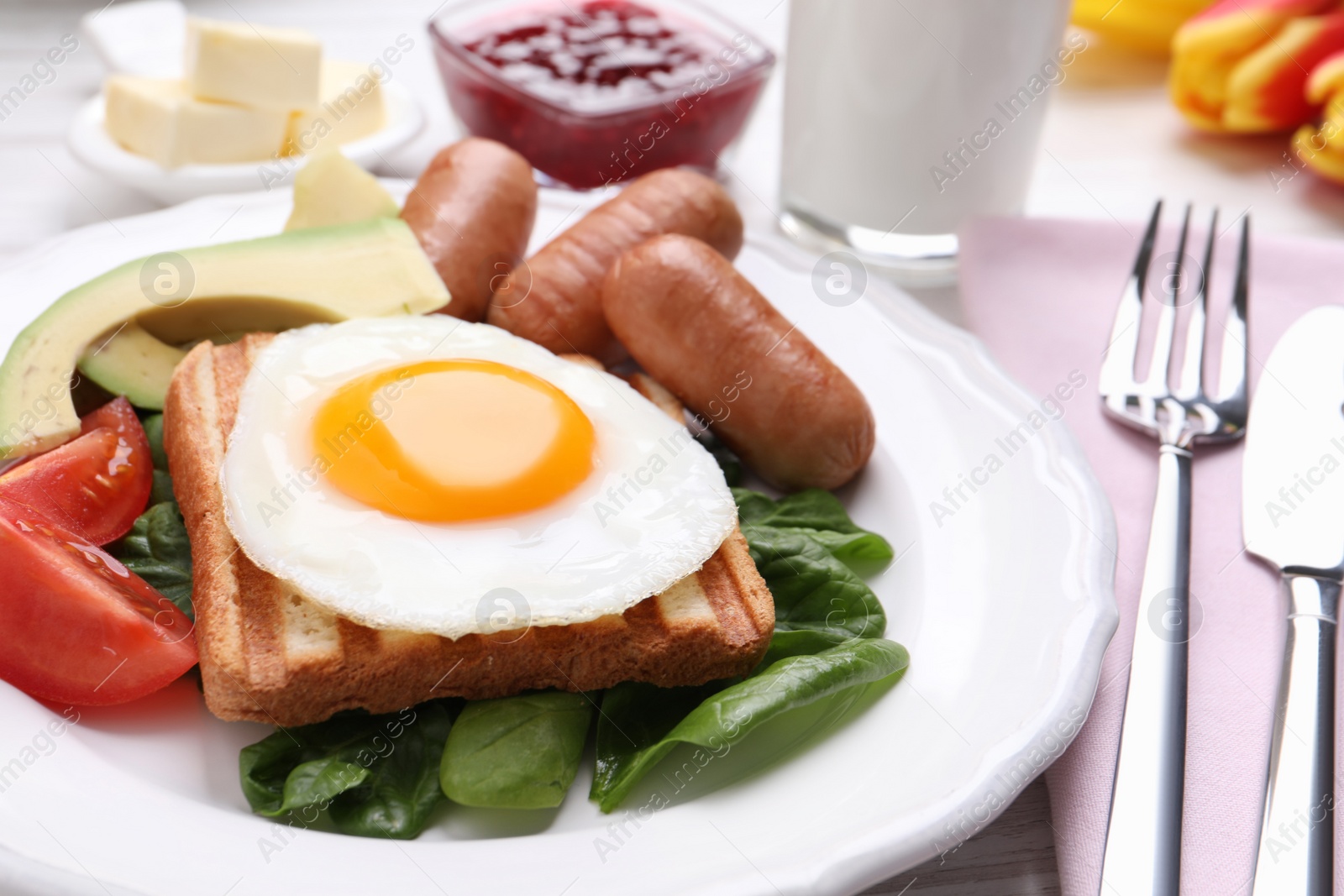 Photo of Delicious breakfast with fried egg served on table, closeup