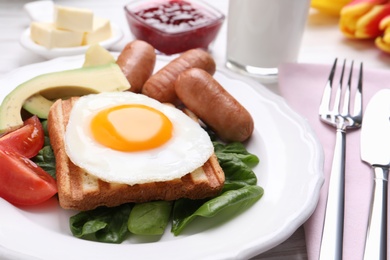 Delicious breakfast with fried egg served on table, closeup