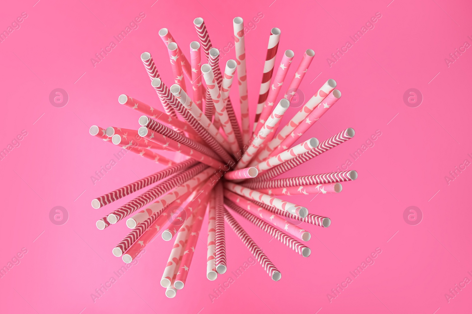 Photo of Many paper drinking straws on pink background, top view