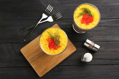 Photo of Traditional russian salad Mimosa served on dark wooden table, flat lay
