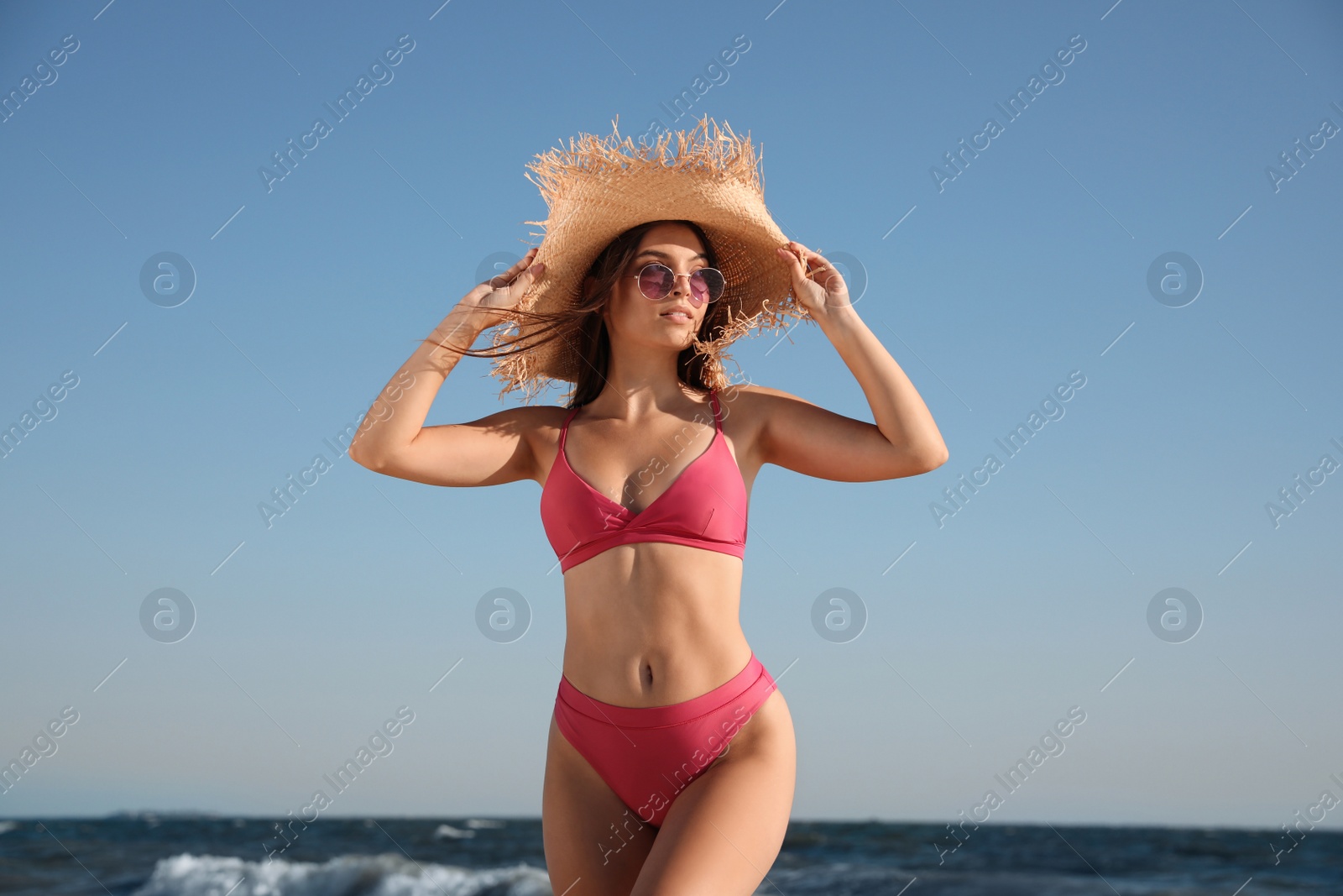 Photo of Beautiful young woman with attractive body on beach