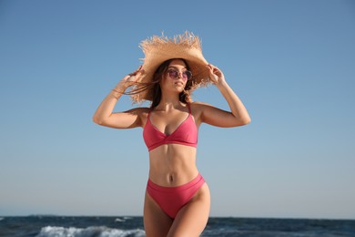 Beautiful young woman with attractive body on beach