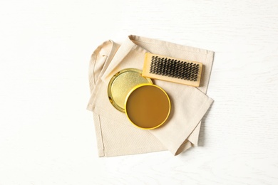 Shoe care accessories on white wooden table, top view