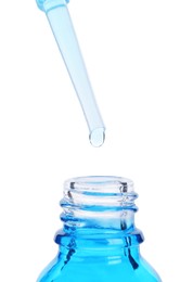 Photo of Dripping liquid from pipette into bottle isolated on white, closeup