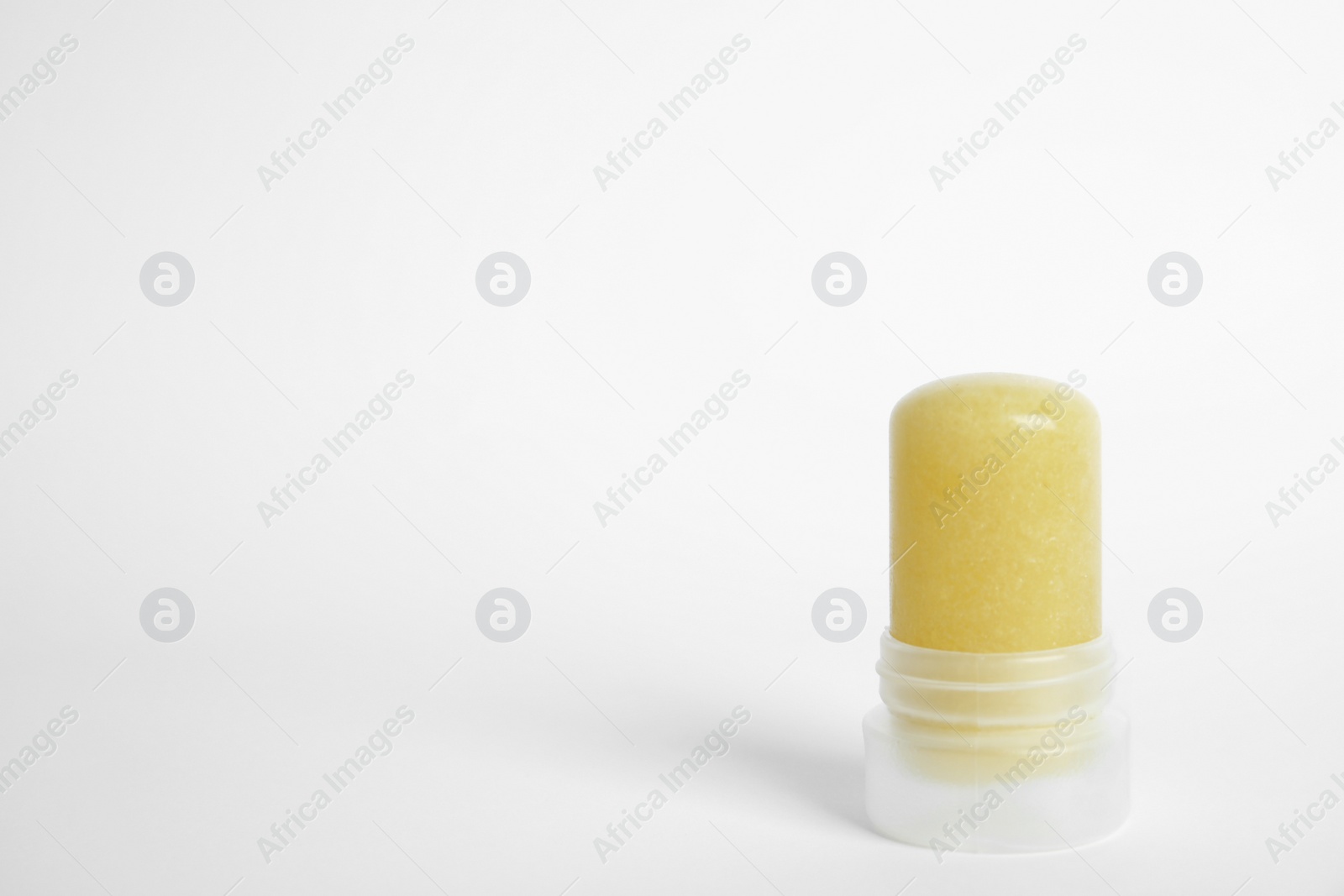 Photo of Natural crystal alum stick deodorant on white background