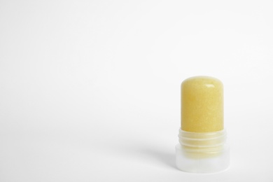 Natural crystal alum stick deodorant on white background