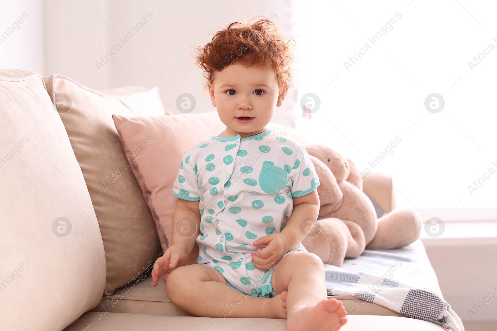 Photo of Portrait of cute little child on sofa at home