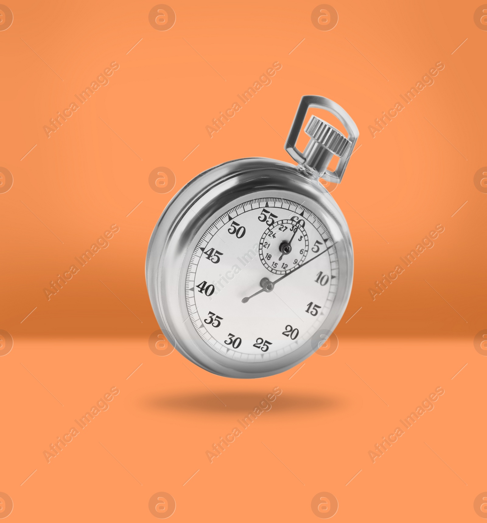 Image of Concept of time. Vintage timer in air on orange background