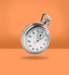 Image of Concept of time. Vintage timer in air on orange background