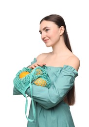 Woman with string bag of fresh lemons on white background