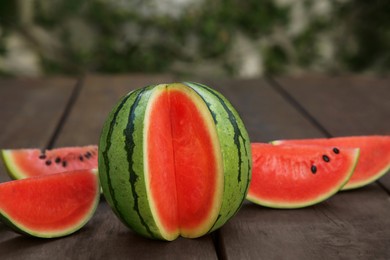 Delicious cut ripe watermelons on wooden table