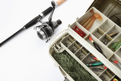 Box with tackle and fishing rod on white background