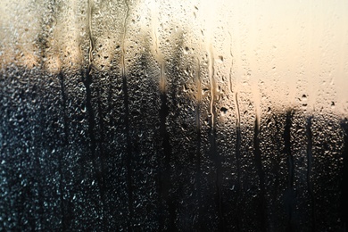 Photo of Rain drops on window glass as background, closeup