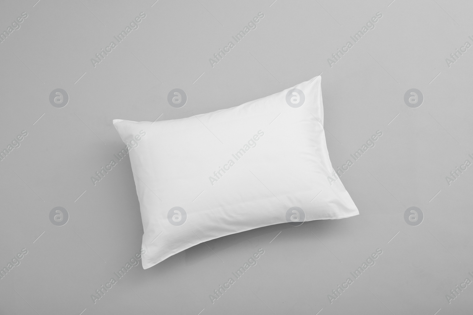 Photo of Clean soft bed pillow on grey background, top view