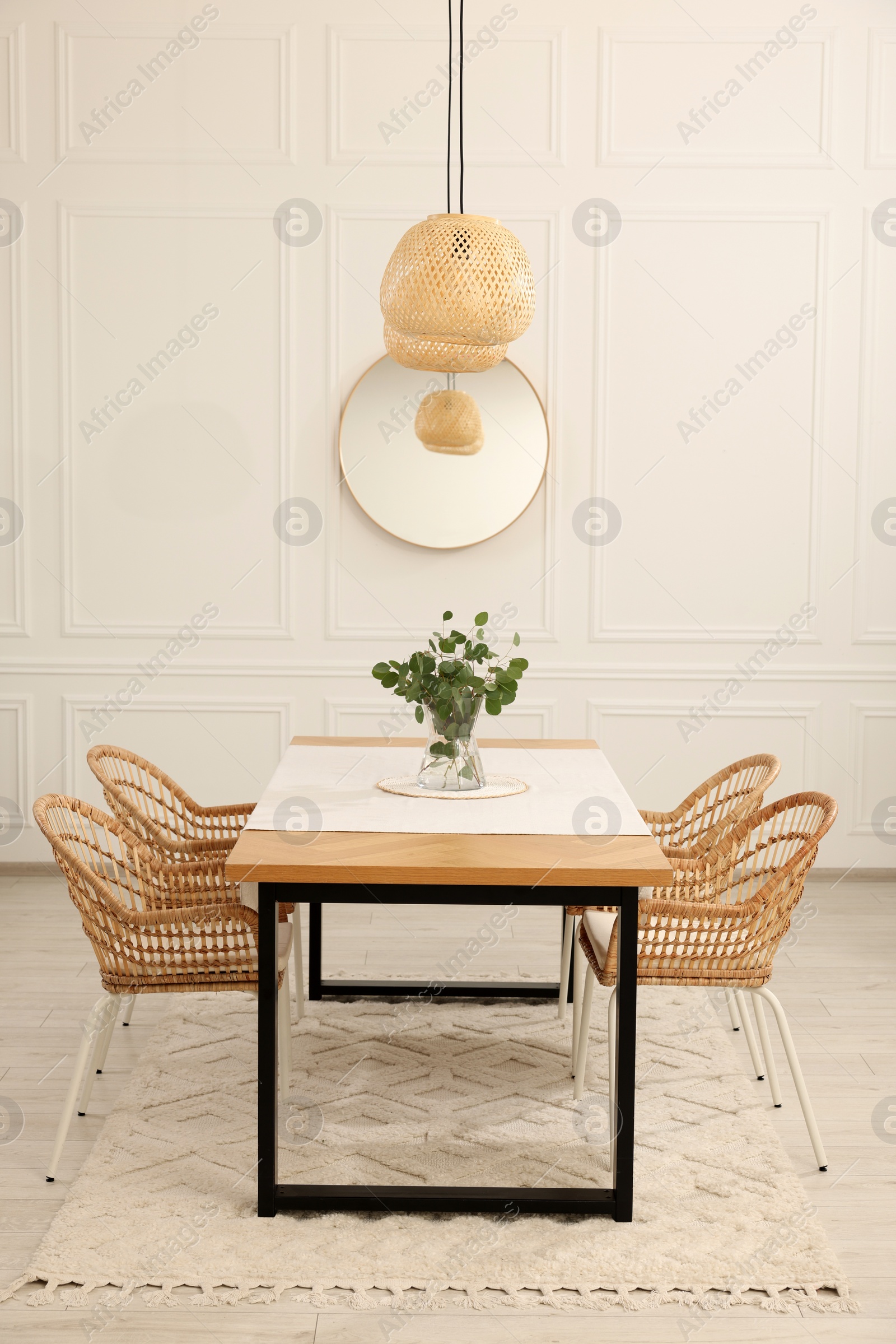 Photo of Stylish dining room with cozy furniture, mirror and plants