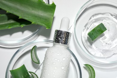 Flat lay composition with cosmetic products and cut aloe vera on white background