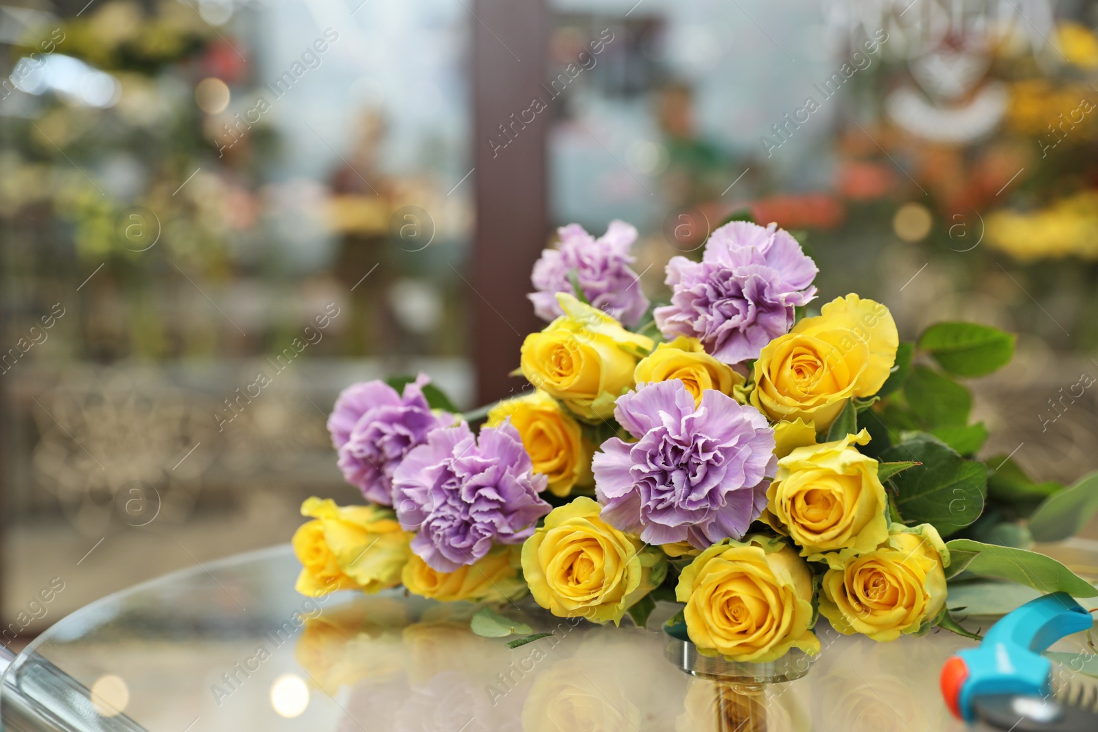 Photo of Beautiful bouquet on table in flower shop. Florist's workplace