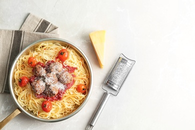 Pasta with meatballs and tomato sauce on light background