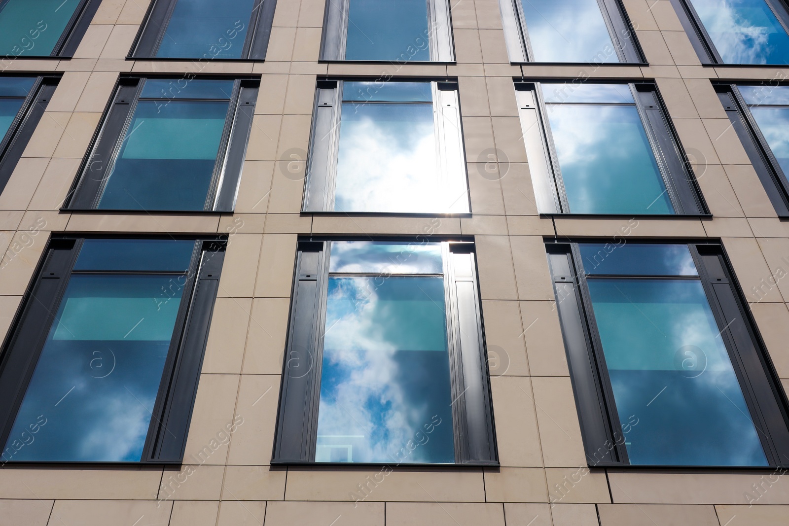 Photo of Modern building with tined windows, low angle view